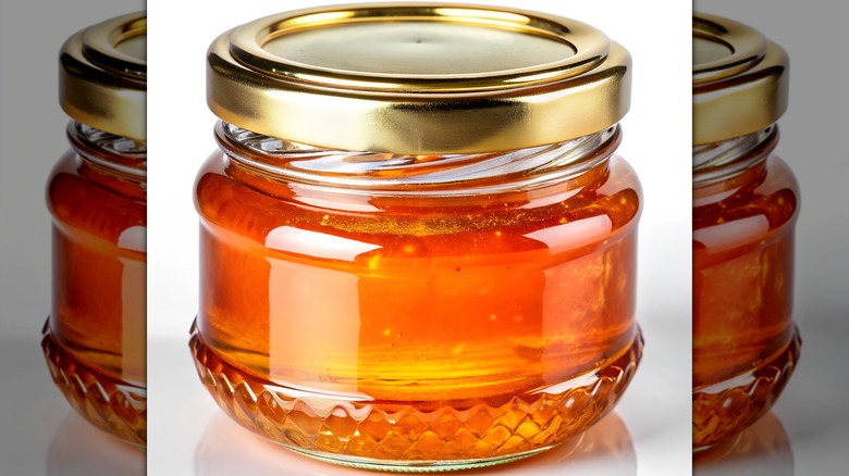 Closeup of a glass jar of honey