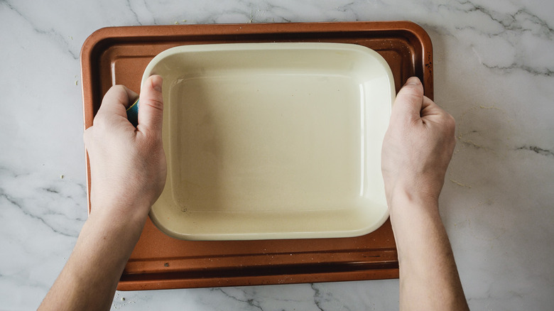 pressing casserole dish down