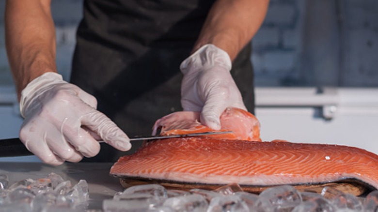 man fileting salmon