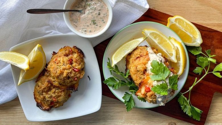Crab balls on plates with lemon wedges and remoulade