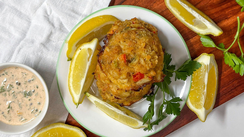 Crab balls on plate with lemon wedges and remoulade