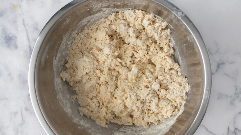 shaggy empanada dough in bowl
