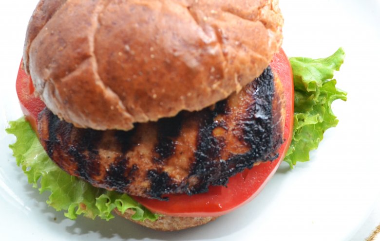 A chicken sandwich on a white background