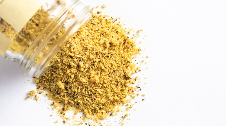 Jar spilling lemon pepper seasoning
