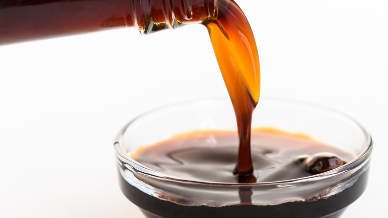 Pouring liquid aminos into bowl