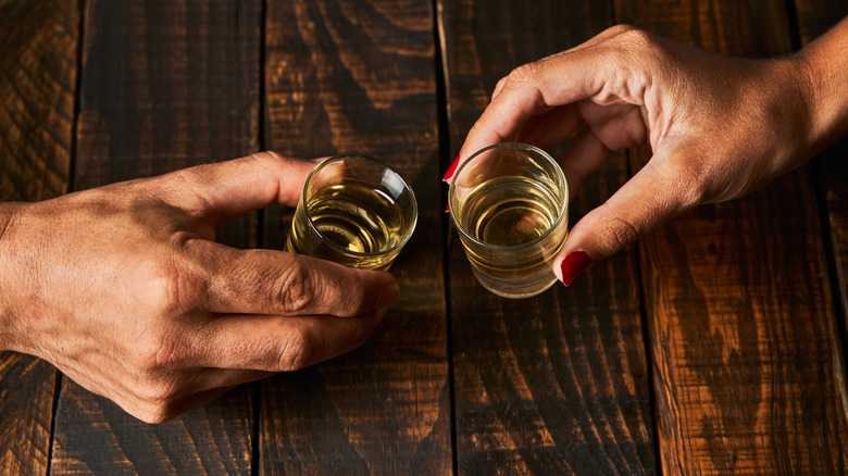People taking shots of bourbon