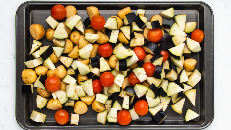 Potatoes and veg on baking sheet