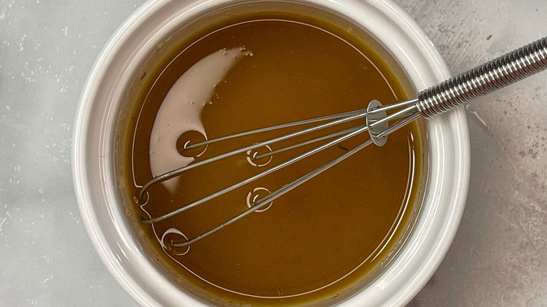 Vinaigrette in bowl with whisk