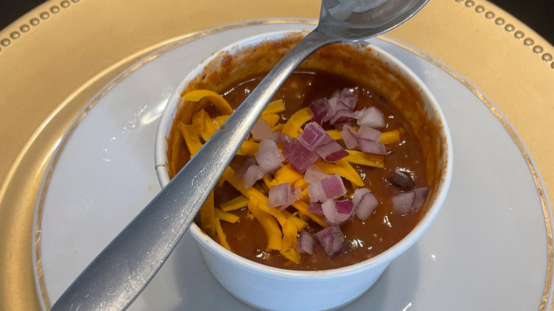 onion cheese chili in bowl