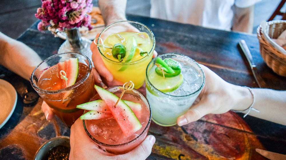 People toasting with cocktails