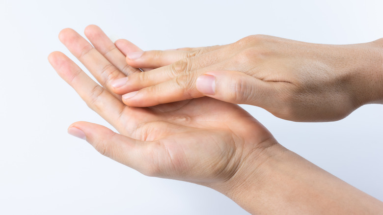 Touching palm of hand